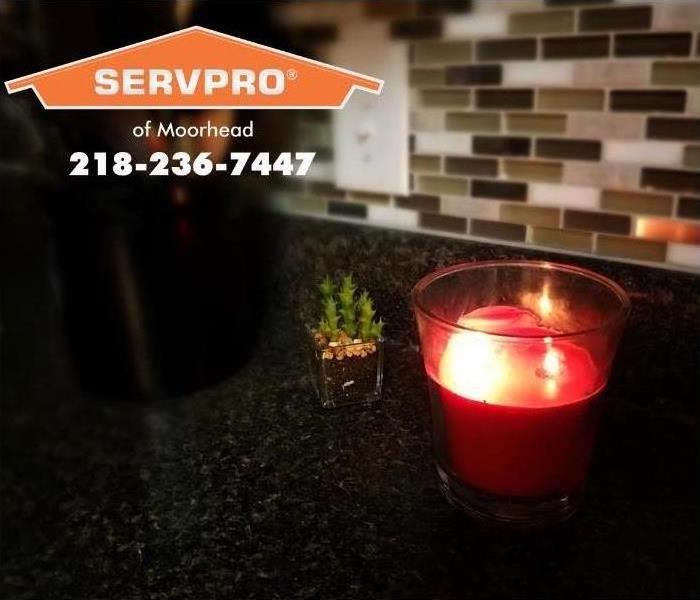 red candle on kitchen countertop 